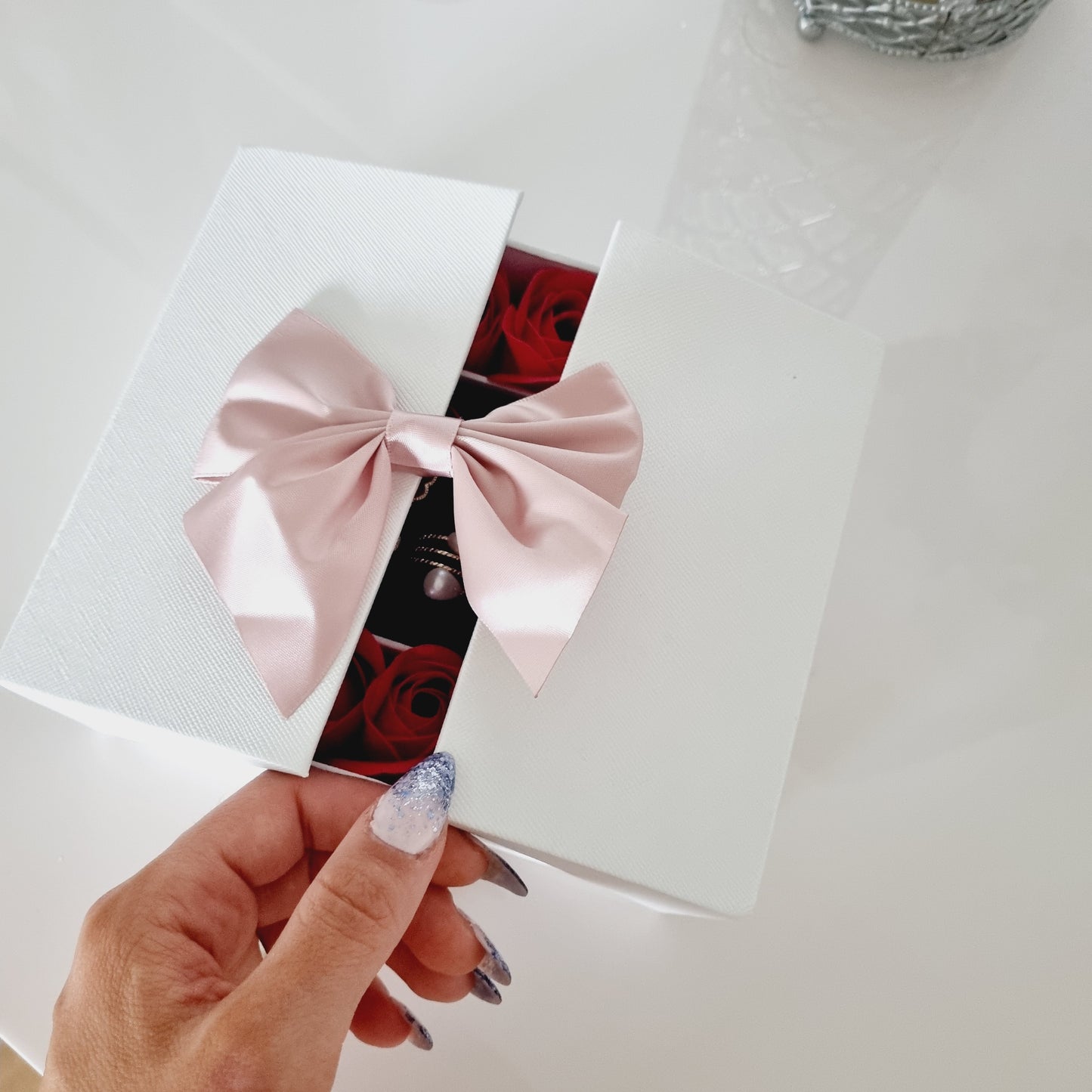 Coffret cadeau avec bijoux dorés et roses rouges ouverture