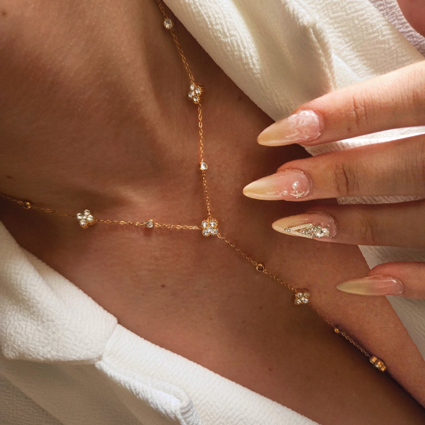 Collier sautoir à fleurs et pierres brillantes en acier inoxydable porté