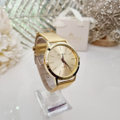 Montre dorée, à cadran doré rond