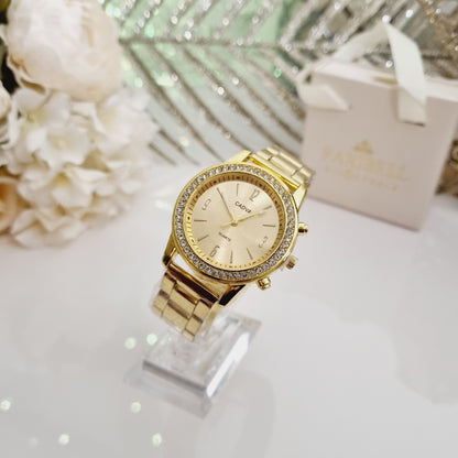Montre dorée, à cadran rond doré orné de strass